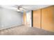 Bedroom with ceiling fan, neutral carpet, and closet space at 9946 W Cornell Pl, Lakewood, CO 80227