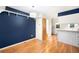 Open dining area with hardwood floors, modern lighting, and seamless access to kitchen at 9946 W Cornell Pl, Lakewood, CO 80227