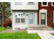 Close-up of a well-maintained two-story townhome with a lovely front yard and charming entrance at 9946 W Cornell Pl, Lakewood, CO 80227