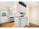Bright kitchen with stainless steel appliances, stylish backsplash, and hardwood floors at 9946 W Cornell Pl, Lakewood, CO 80227