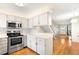 Well-lit kitchen area with stainless steel appliances and seamless transition to the open living space at 9946 W Cornell Pl, Lakewood, CO 80227