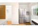 Kitchen featuring stainless steel fridge, bright light, and an adjacent closet at 9946 W Cornell Pl, Lakewood, CO 80227
