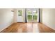 Hardwood floors, a back door and a large window fill this well-lit living room at 9946 W Cornell Pl, Lakewood, CO 80227