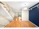 Spacious area with hardwood floors, stairs, a feature wall and back door access at 9946 W Cornell Pl, Lakewood, CO 80227