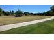 Large grassy area with mature trees and bushes and a sidewalk for a walking path at 430 Zang St # 4-102, Lakewood, CO 80228