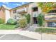 Multi-level condo building with well-kept landscaping and walkways to building entrances at 430 Zang St # 4-102, Lakewood, CO 80228