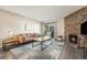 Inviting living room featuring a stone fireplace, plush sofa, and abundant natural light at 430 Zang St # 4-102, Lakewood, CO 80228