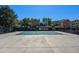 Community pool is covered and surrounded by a dark metal fence with building in the background at 430 Zang St # 4-102, Lakewood, CO 80228