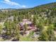A secluded modern mountain home, surrounded by lush forest, offers privacy and scenic views at 8791 Grizzly Way, Evergreen, CO 80439