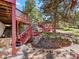 Backyard with stairs and mature trees at 8791 Grizzly Way, Evergreen, CO 80439