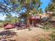 Backyard featuring deck and mature trees at 8791 Grizzly Way, Evergreen, CO 80439