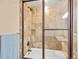 Bathroom featuring a glass-enclosed shower over tub at 8791 Grizzly Way, Evergreen, CO 80439