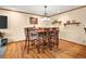 Bright dining room with hardwood floors and warm, inviting lighting at 8791 Grizzly Way, Evergreen, CO 80439