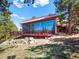 Exterior view of a home with a large glass wall at 8791 Grizzly Way, Evergreen, CO 80439