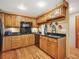 Kitchen features granite countertops, wood cabinets, stainless appliances, and hardwood floors at 8791 Grizzly Way, Evergreen, CO 80439