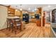 Open kitchen with breakfast bar, stainless steel appliances, hardwood floors, and wooden cabinets at 8791 Grizzly Way, Evergreen, CO 80439