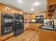 Well-lit kitchen with wood cabinets, stainless steel appliances, granite countertops and hardwood floors at 8791 Grizzly Way, Evergreen, CO 80439
