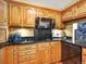 Kitchen with wood cabinets, granite countertops, hardwood floors, and stainless steel appliances at 8791 Grizzly Way, Evergreen, CO 80439