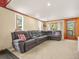 Cozy living room featuring a plush sectional sofa and natural light at 8791 Grizzly Way, Evergreen, CO 80439