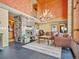 A grand room with beautiful views, large stone fireplace, and gorgeous antler chandelier at 8791 Grizzly Way, Evergreen, CO 80439