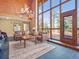 Inviting living room with floor-to-ceiling windows, mountain views, and comfortable seating at 8791 Grizzly Way, Evergreen, CO 80439