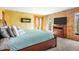 Comfortable main bedroom with a large window and stone accent wall at 8791 Grizzly Way, Evergreen, CO 80439