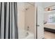 Bathroom with a shower-tub combo and a doorway that shows the bedroom, providing a functional and comfortable space at 9300 E Florida Ave # 906, Denver, CO 80247