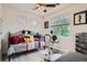 Charming bedroom features a daybed, exercise bike, and bright natural light at 9300 E Florida Ave # 906, Denver, CO 80247