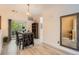 Bright dining area with sliding door access to a balcony, complemented by stylish furnishings and decor at 9300 E Florida Ave # 906, Denver, CO 80247