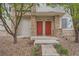 Close up view of the dual red front doors with stone and beige columns at 9300 E Florida Ave # 906, Denver, CO 80247