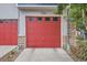 Bright red garage door with multi-paneled windows and a concrete driveway at 9300 E Florida Ave # 906, Denver, CO 80247