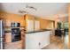 Open kitchen featuring stainless steel appliances, a breakfast bar, and an attached dining area at 9300 E Florida Ave # 906, Denver, CO 80247