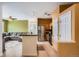 Galley kitchen with stainless steel appliances flows into the living room in this inviting open concept floor plan at 9300 E Florida Ave # 906, Denver, CO 80247