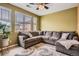 Bright living room with a large sectional couch and a patterned area rug at 9300 E Florida Ave # 906, Denver, CO 80247