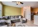 Comfortable living room featuring a large gray sectional couch, and an open doorway at 9300 E Florida Ave # 906, Denver, CO 80247