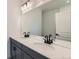 Modern bathroom featuring double sinks, large mirror, and sleek fixtures at 1755 Peak Loop, Broomfield, CO 80023