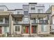 New townhome community with modern facade, balconies, and eye-catching red front doors at 1755 Peak Loop, Broomfield, CO 80023