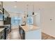 Open kitchen features modern appliances, pendant lighting, and expansive island with bar seating at 1755 Peak Loop, Broomfield, CO 80023