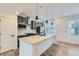 This modern kitchen features a large island, pendant lighting, and sleek stainless steel appliances at 1755 Peak Loop, Broomfield, CO 80023