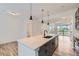 Bright, open kitchen featuring a large island, pendant lighting and modern appliances at 1755 Peak Loop, Broomfield, CO 80023