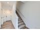 Brightly lit staircase with carpeted stairs and wooden floors at 1755 Peak Loop, Broomfield, CO 80023