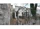 Cozy backyard framed by mature trees, a garden gate, a brick house, and a wooden fence at 553 N Logan St, Denver, CO 80203