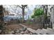 Backyard with a stone walkway, wooden fence, some mature trees, and a bit of landscaping at 553 N Logan St, Denver, CO 80203