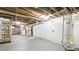 Unfinished basement featuring exposed ceiling, whitewashed brick walls, and concrete floor at 553 N Logan St, Denver, CO 80203