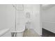 This bathroom features a vintage-style tub, a toilet, a pedestal sink, and neutral tiling at 553 N Logan St, Denver, CO 80203