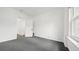 A bedroom with neutral-colored carpet, a window, white walls, and a view to the hallway at 553 N Logan St, Denver, CO 80203