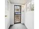 Enclosed porch entry with decorative security gate and white brick walls at 553 N Logan St, Denver, CO 80203