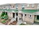 Charming townhome exterior with green roofing and well-manicured landscaping and inviting entryways at 553 N Logan St, Denver, CO 80203
