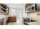 This kitchen is equipped with stainless steel appliances, granite countertops, and wood cabinets at 553 N Logan St, Denver, CO 80203