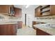 An updated kitchen with stainless steel appliances, granite countertops, and wood cabinets at 553 N Logan St, Denver, CO 80203